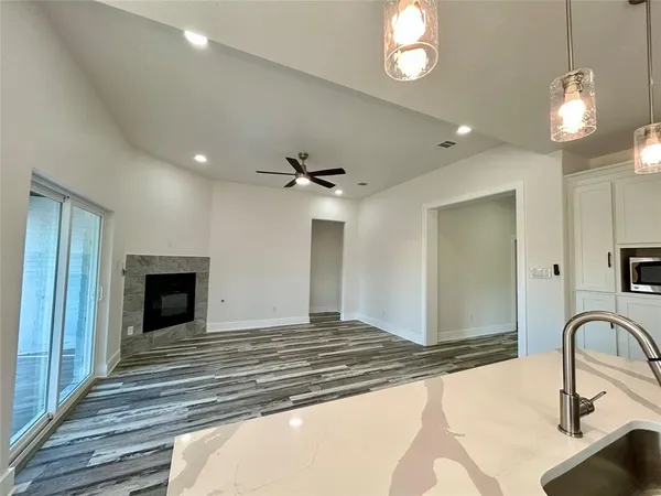 a kitchen with kitchen island a sink stainless steel appliances and cabinets
