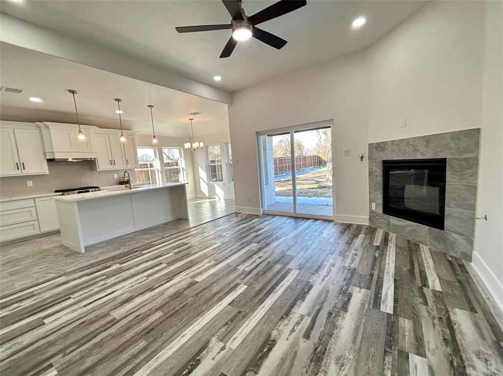 802 South Medora Street Terrell, TX 75160 - Photo 23 of 34 a open kitchen with kitchen island a stove a sink and a refrigerator