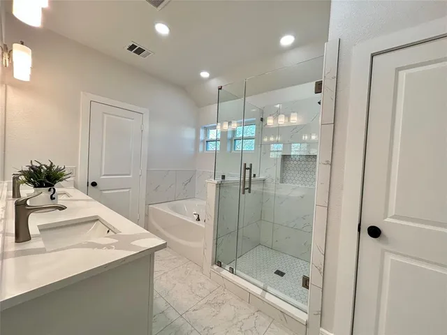 a bathroom with a shower sink and mirror