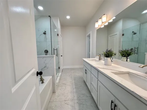 a spacious bathroom with a bathtub sink and mirror