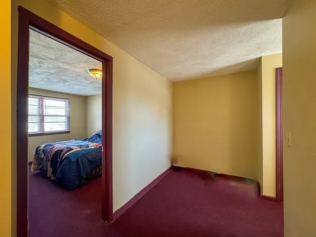 a view of bedroom with a bed and a window