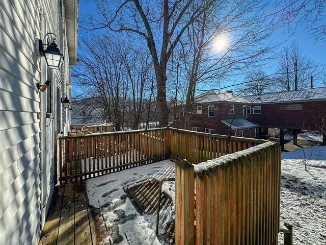 a view of balcony with wooden floor and fence