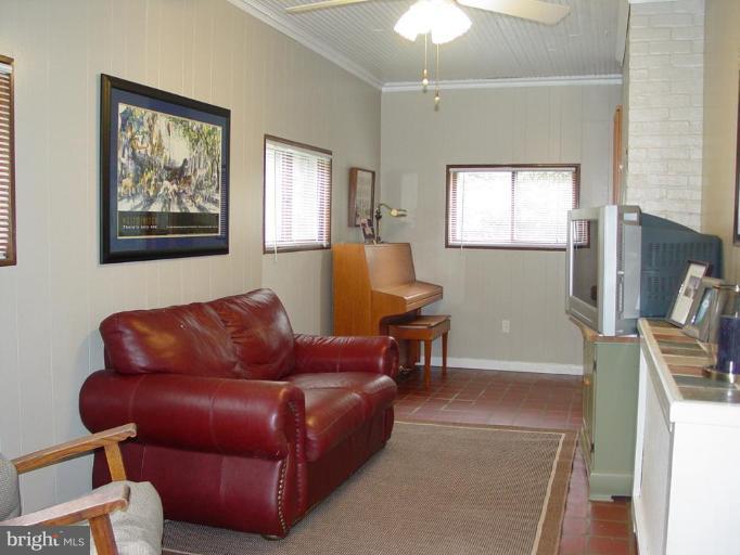 6305 Pinehurst Road Baltimore, MD 21212 - Photo 6 of 23 Terra cotta floored family room w/ ceiling fan.