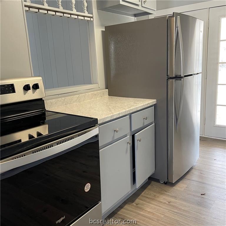 3755 West Villa Maria Road Bryan, TX 77807 - Photo 10 of 26 Kitchen featuring stainless steel appliances, light countertops, gray cabinets, and light wood-style flooring