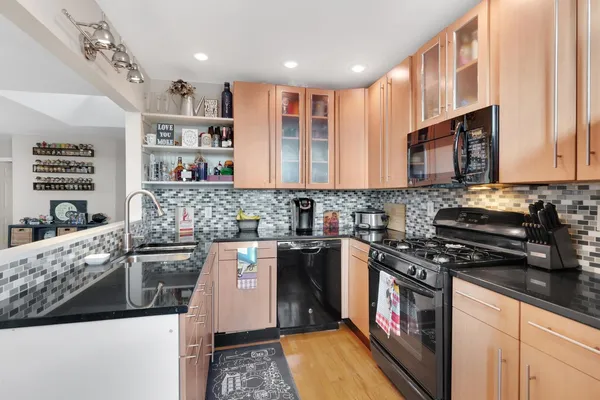 a kitchen with stainless steel appliances granite countertop a stove and a sink