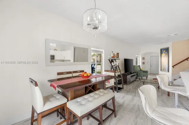 a dining room with furniture and window