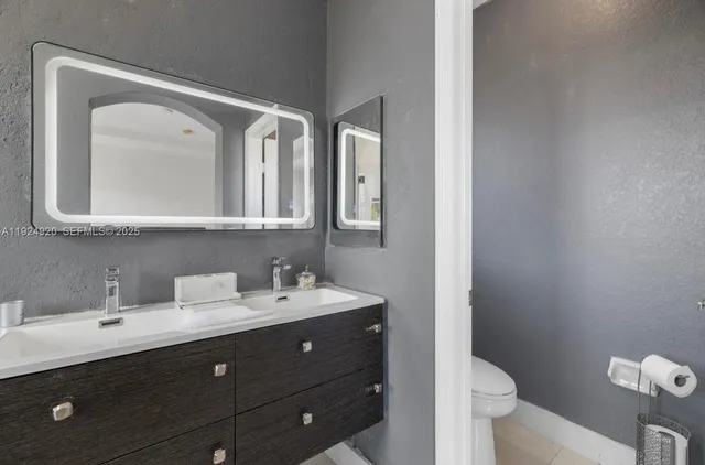 a bathroom with a double vanity sink and a mirror
