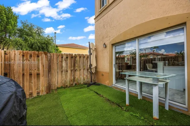 a view of an chairs with table in balcony