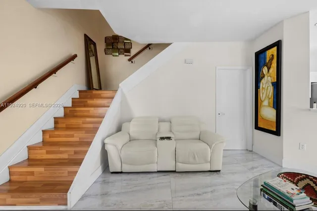 a living room with furniture and stairs