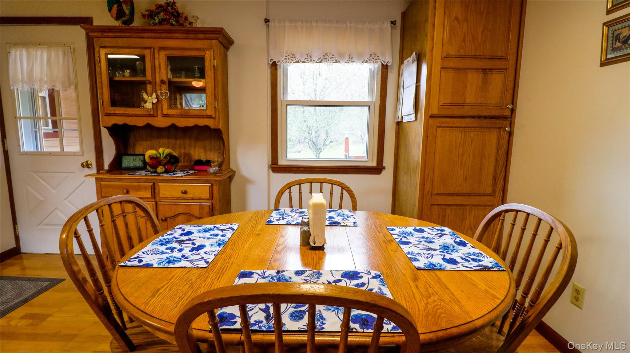 11 Hood Road Roscoe, NY 12776 - Photo 13 of 31 Dining area with wood-finish flooring, a window offering natural light, and built-in wood cabinetry for storage
