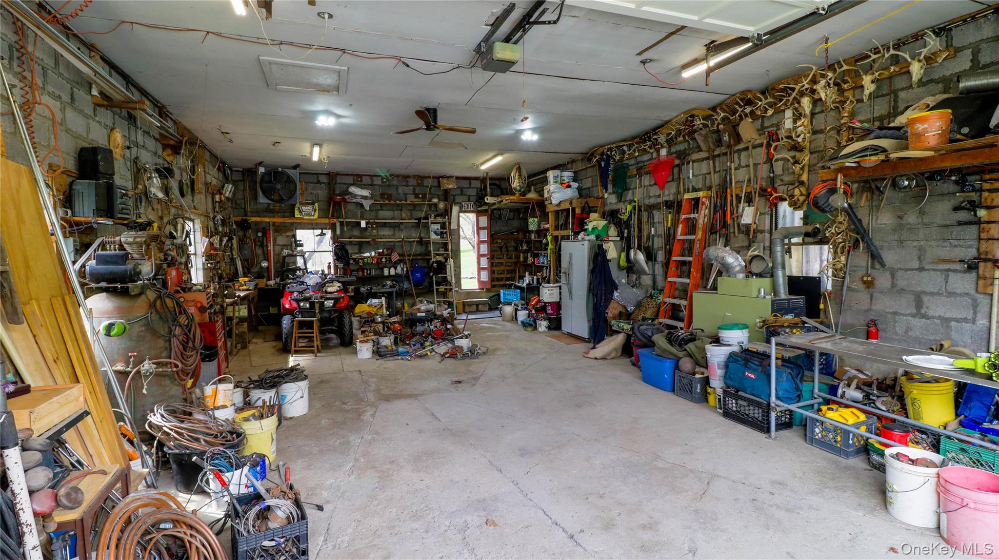 11 Hood Road Roscoe, NY 12776 - Photo 27 of 31 Spacious garage featuring concrete block walls, a concrete floor, and multiple windows