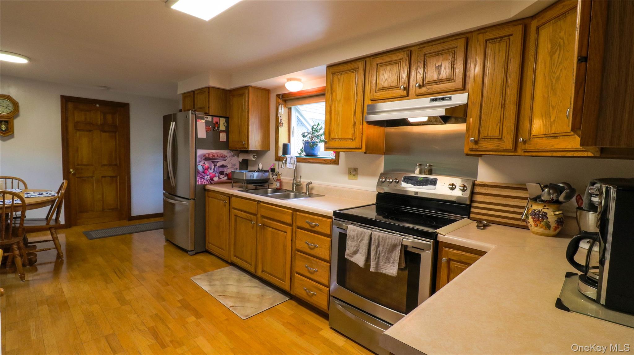 11 Hood Road Roscoe, NY 12776 - Photo 10 of 31 Kitchen featuring wood-finish flooring, ample wood cabinetry, and stainless steel appliances including a refrigerator and range