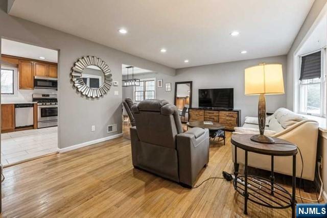 23 Asmus Road Closter, NJ 07624 - Photo 6 of 38 a living room with furniture and a flat screen tv