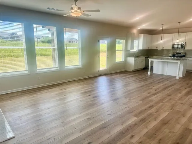 a view of kitchen with stove and wooden floor