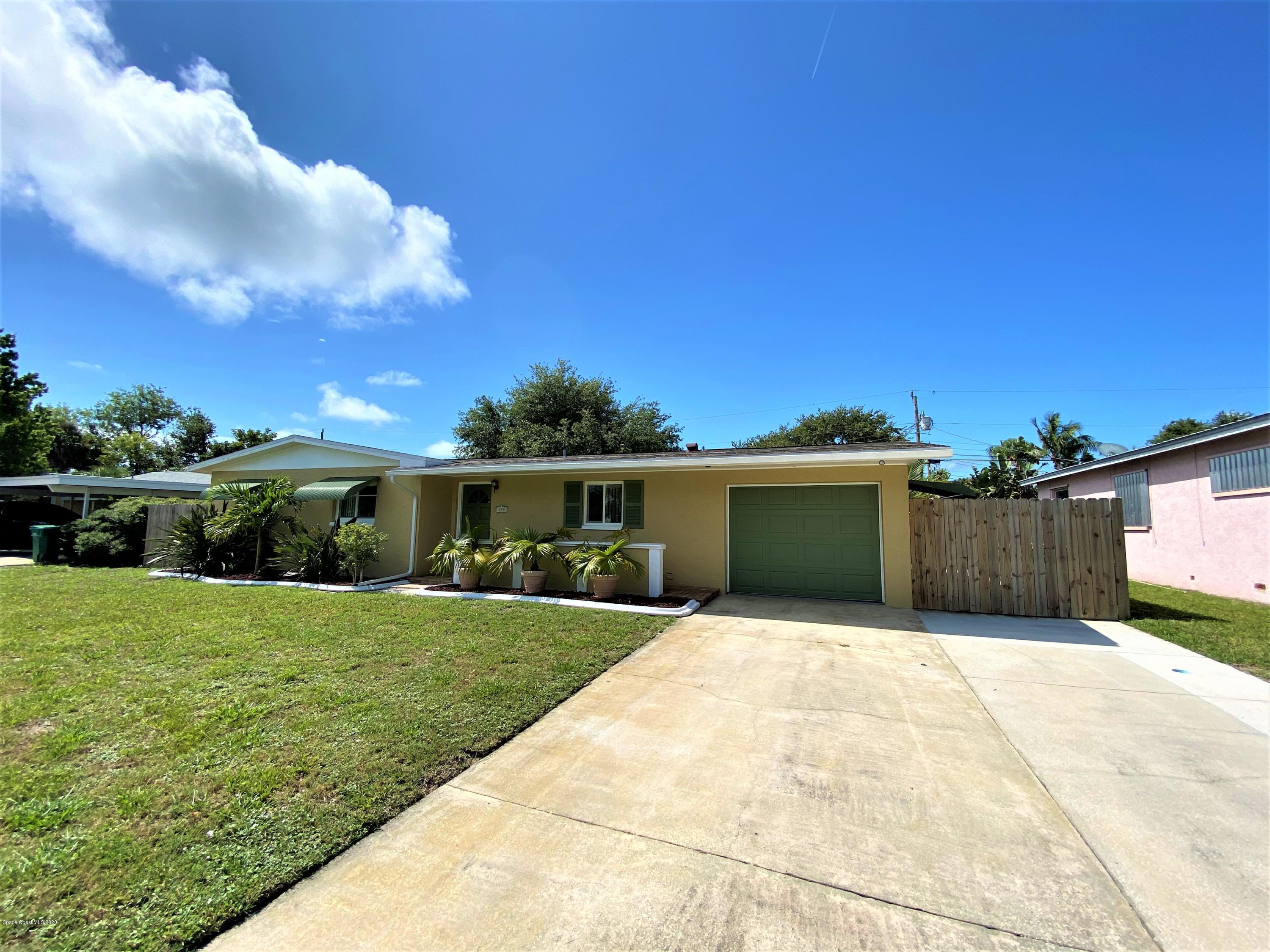 175 Tiki Drive Merritt Island, FL 32953 - Photo 1 of 15 front view of a house with a yard