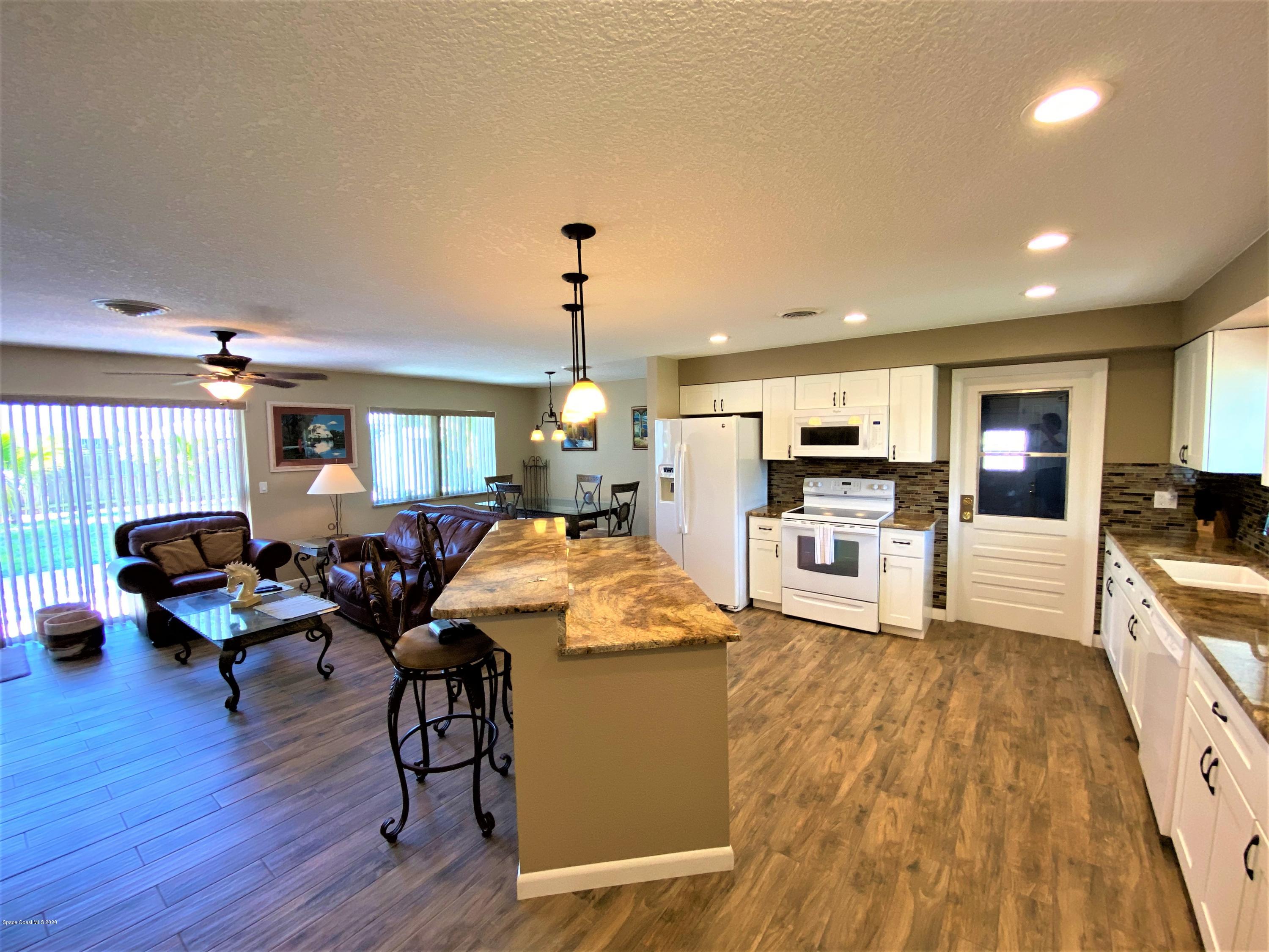175 Tiki Drive Merritt Island, FL 32953 - Photo 2 of 15 a living room with furniture and kitchen view