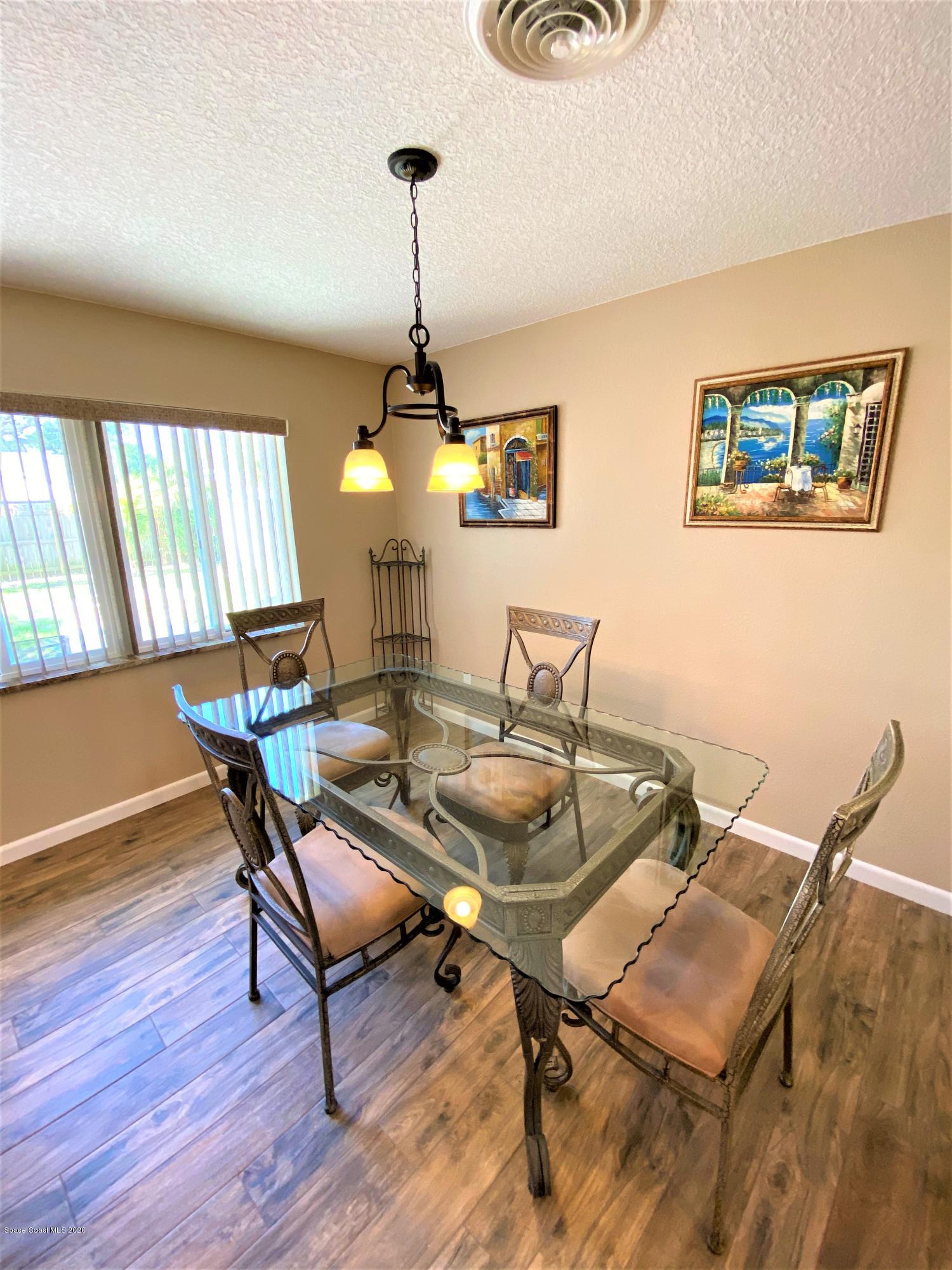 175 Tiki Drive Merritt Island, FL 32953 - Photo 7 of 15 a dining room with furniture and wooden floor