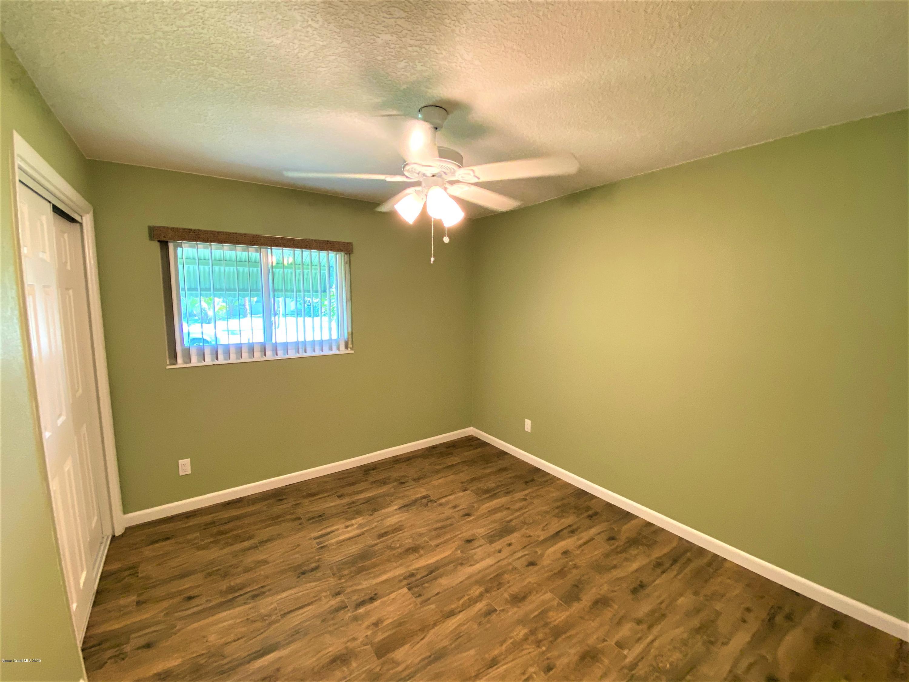 175 Tiki Drive Merritt Island, FL 32953 - Photo 10 of 15 an empty room with a window and a ceiling fan