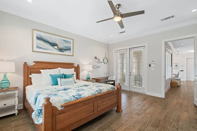 a bedroom with a large bed and a chandelier