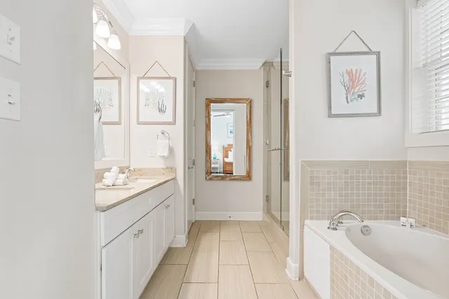 a bathroom with a tub sink and mirror
