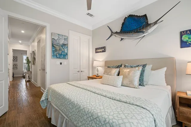 a bedroom with bed and wooden floor