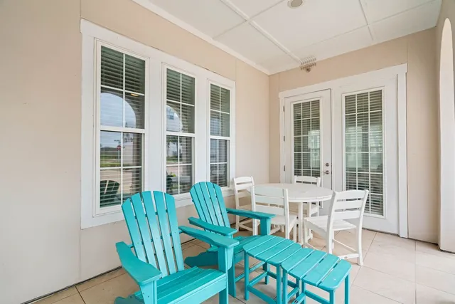 a view of a dining room with furniture and windows