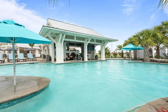 a view of a house with backyard porch and sitting area