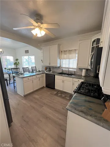 a kitchen with stainless steel appliances granite countertop a stove sink and cabinets
