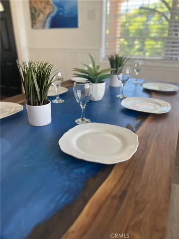a dining room with furniture and potted plant