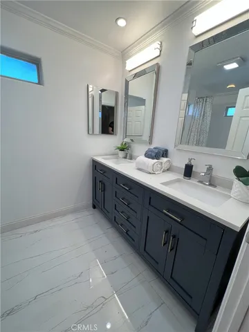 a spacious bathroom with a double vanity sink and mirror