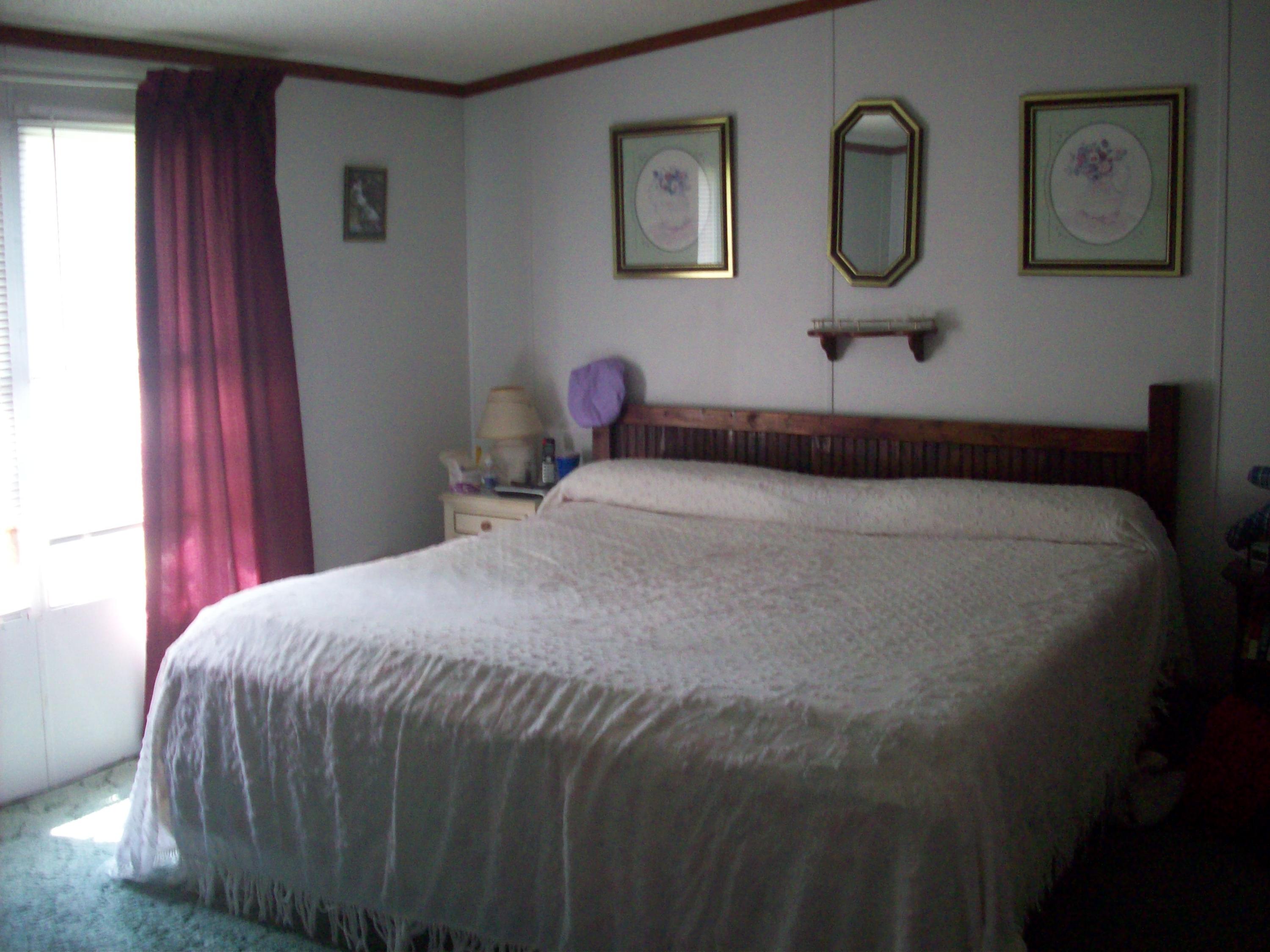 205 Board Mountain Road Goodview, VA 24095 - Photo 4 of 17 a bedroom with a bed and painted walls