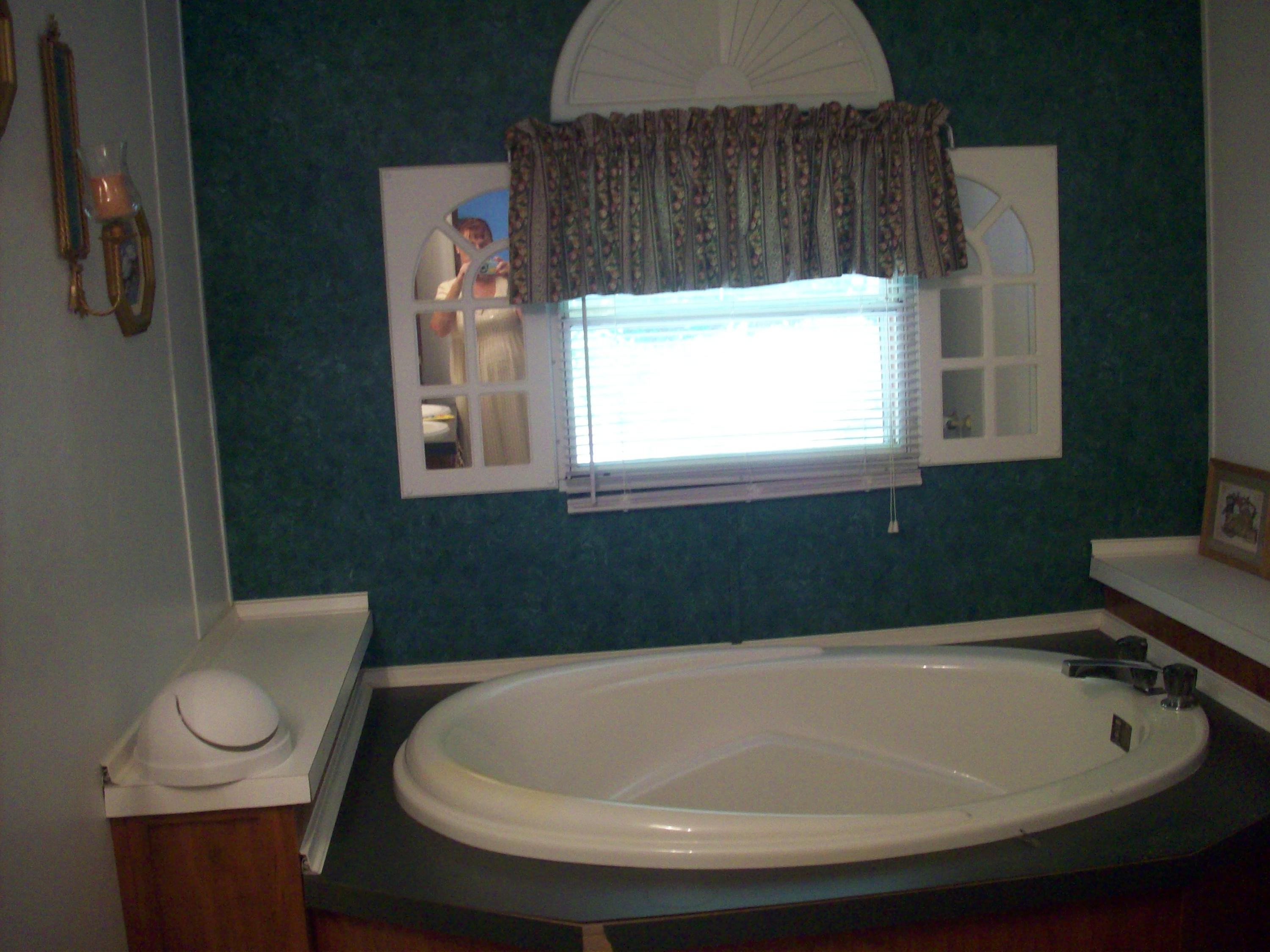 205 Board Mountain Road Goodview, VA 24095 - Photo 6 of 17 a bathroom with a toilet a sink and a window
