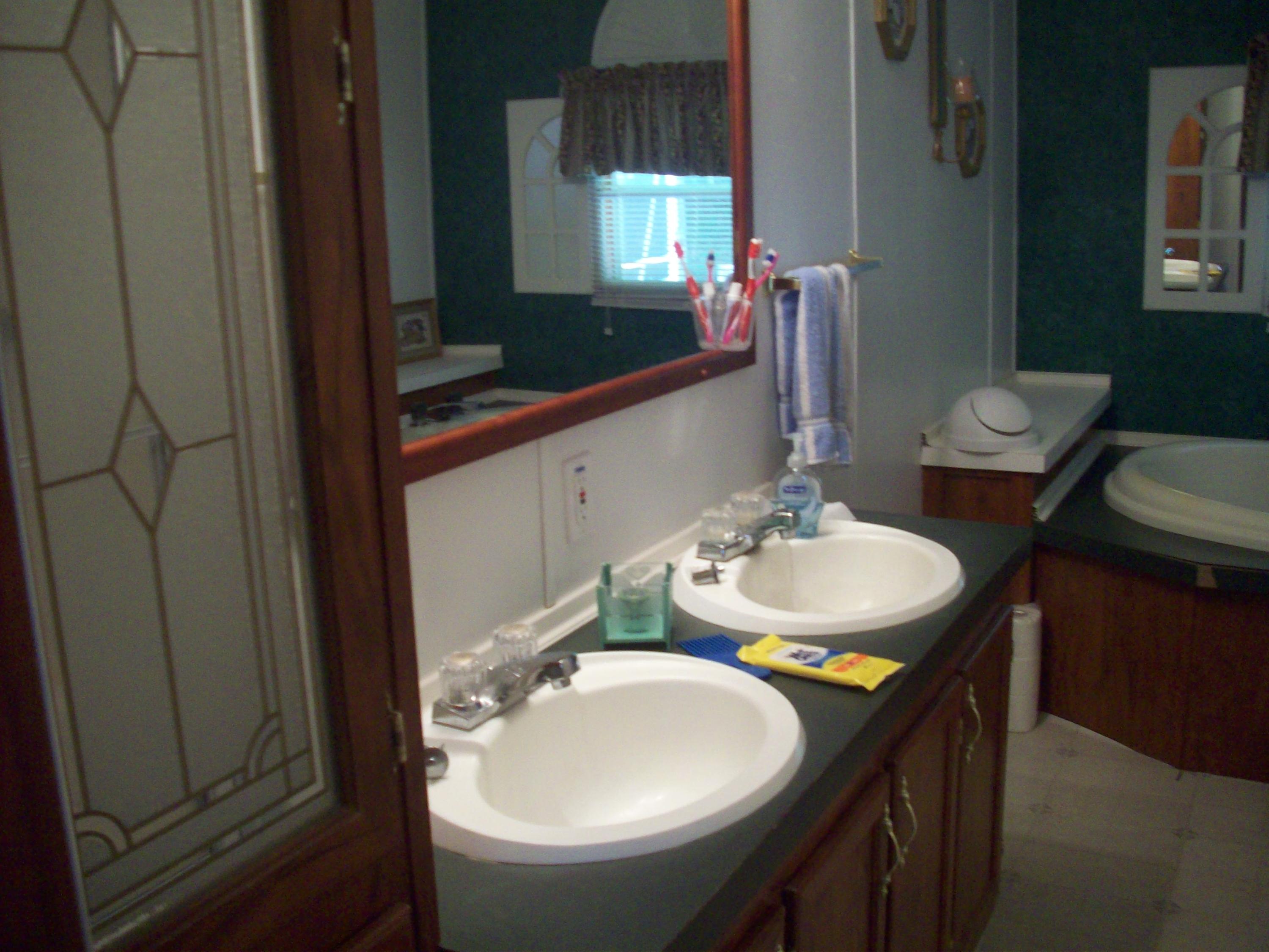 205 Board Mountain Road Goodview, VA 24095 - Photo 7 of 17 a bathroom with a sink and a mirror