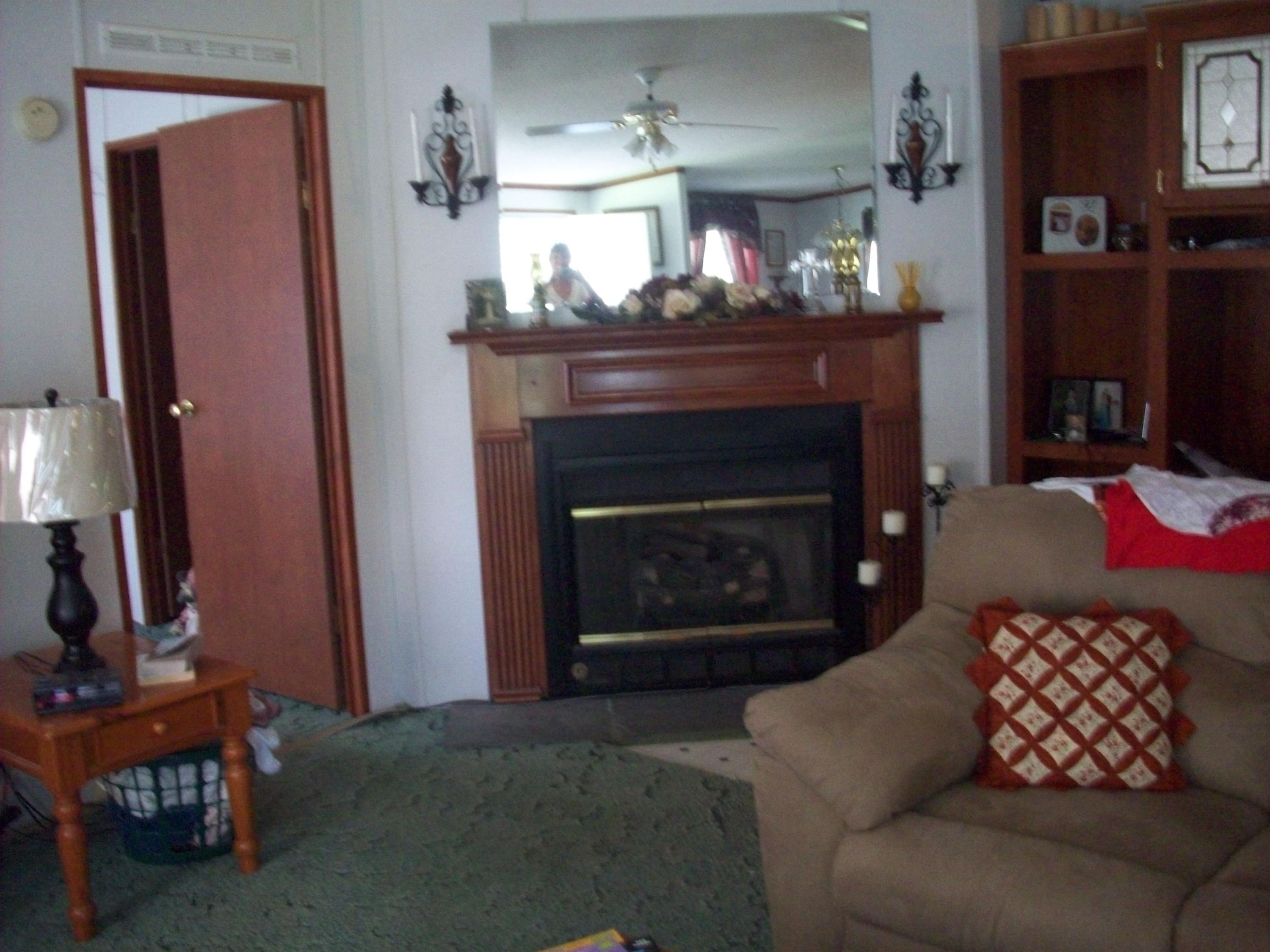 205 Board Mountain Road Goodview, VA 24095 - Photo 9 of 17 a living room with furniture and a fireplace