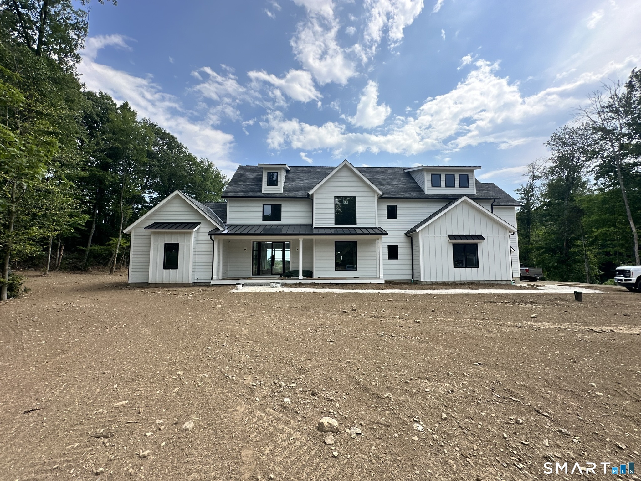 8 Stone Bridge Trail Newtown, CT 06482 - Photo 3 of 6 a front view of a house with a yard and garage