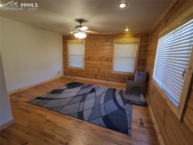 a view of a room with wooden floor and staircase