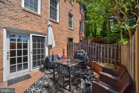 a view of a chairs and a table in the back yard of the house
