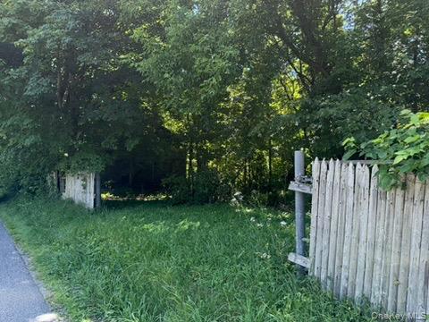 22 Beilke Road Millerton, NY 12546 - Photo 27 of 30 a view of a backyard with large trees and wooden fence