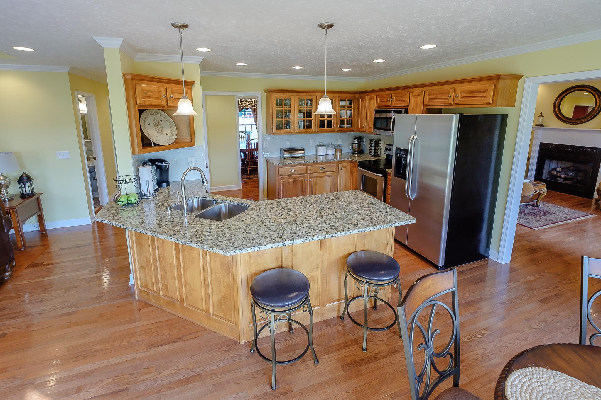 329 Urban Farms Road Manchester, TN 37355 - Photo 12 of 29 a kitchen with stainless steel appliances granite countertop a refrigerator a stove top oven and cabinets with wooden floor