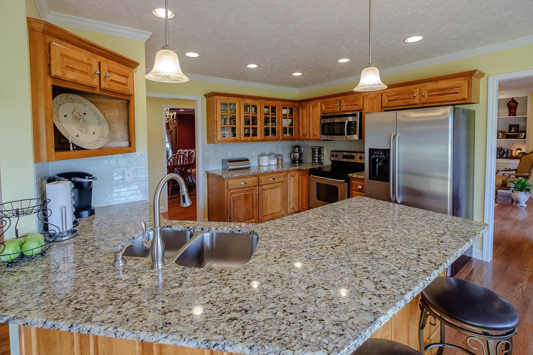 329 Urban Farms Road Manchester, TN 37355 - Photo 13 of 29 a kitchen with stainless steel appliances granite countertop a sink a stove top oven a granite counter space and stainless steel appliances