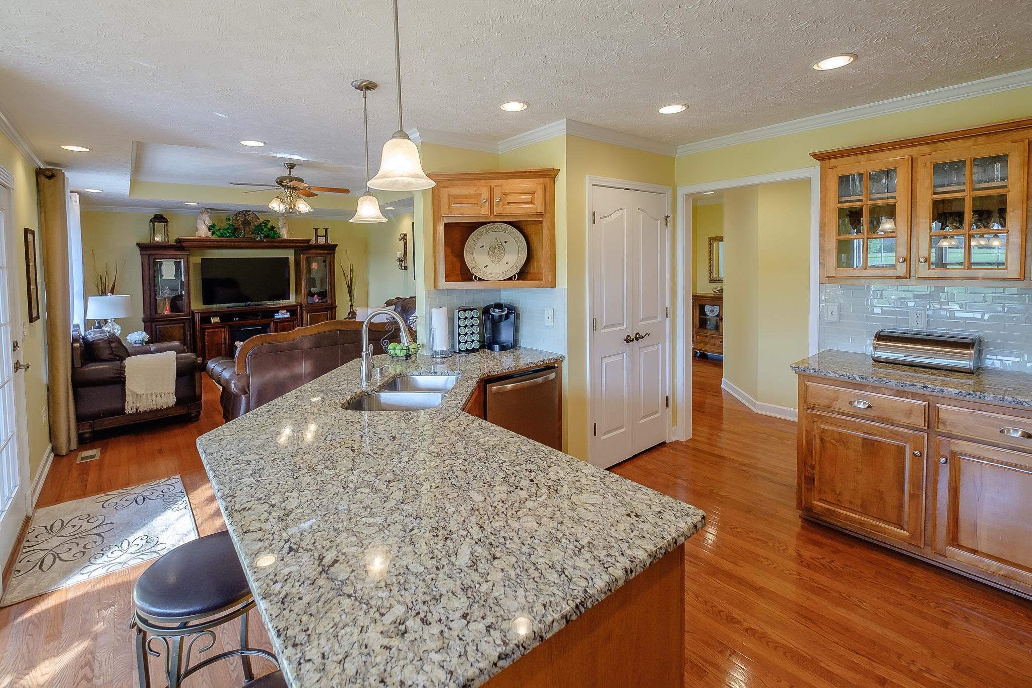 329 Urban Farms Road Manchester, TN 37355 - Photo 14 of 29 a large kitchen with stainless steel appliances granite countertop a stove and large wooden cabinets