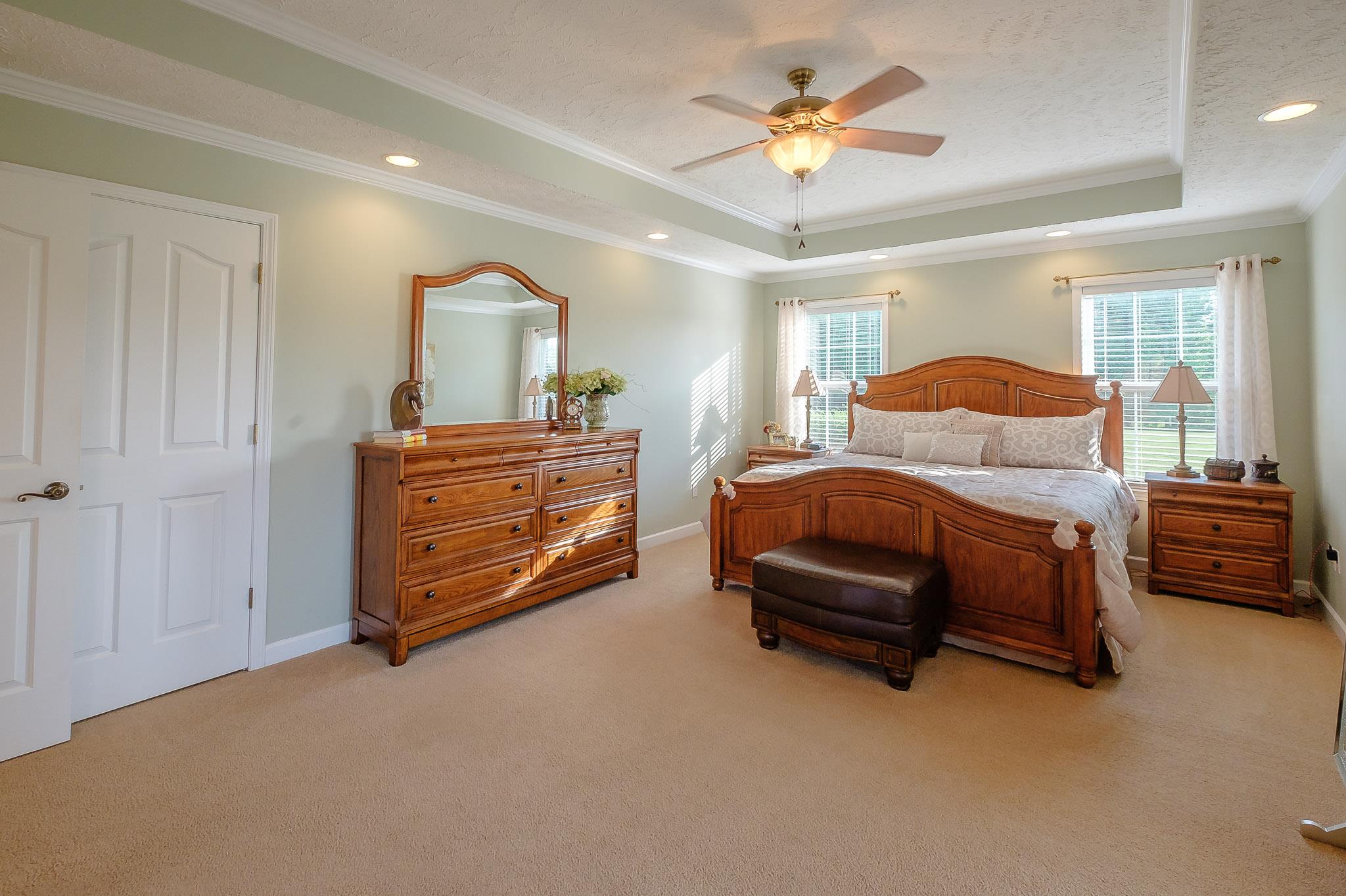 329 Urban Farms Road Manchester, TN 37355 - Photo 18 of 29 a bedroom with a bed and a chandelier