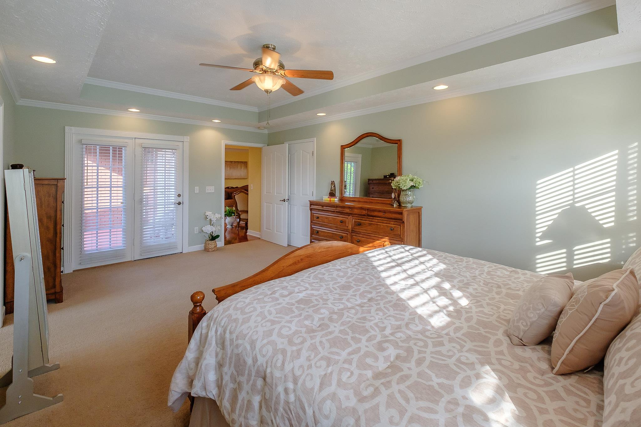 329 Urban Farms Road Manchester, TN 37355 - Photo 19 of 29 a bedroom with a bed and a chandelier