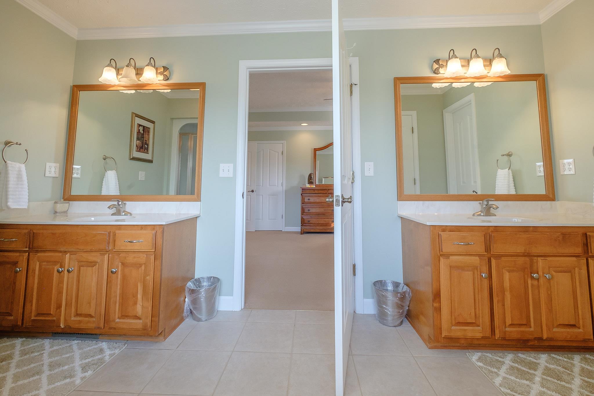 329 Urban Farms Road Manchester, TN 37355 - Photo 20 of 29 a bathroom with a double vanity sink and a mirror