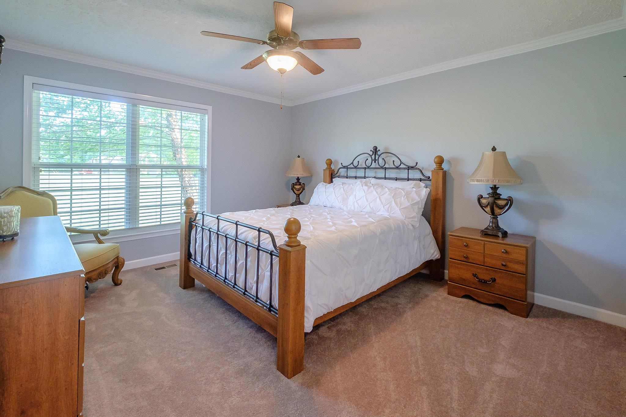 329 Urban Farms Road Manchester, TN 37355 - Photo 23 of 29 a bedroom with a bed and a chandelier