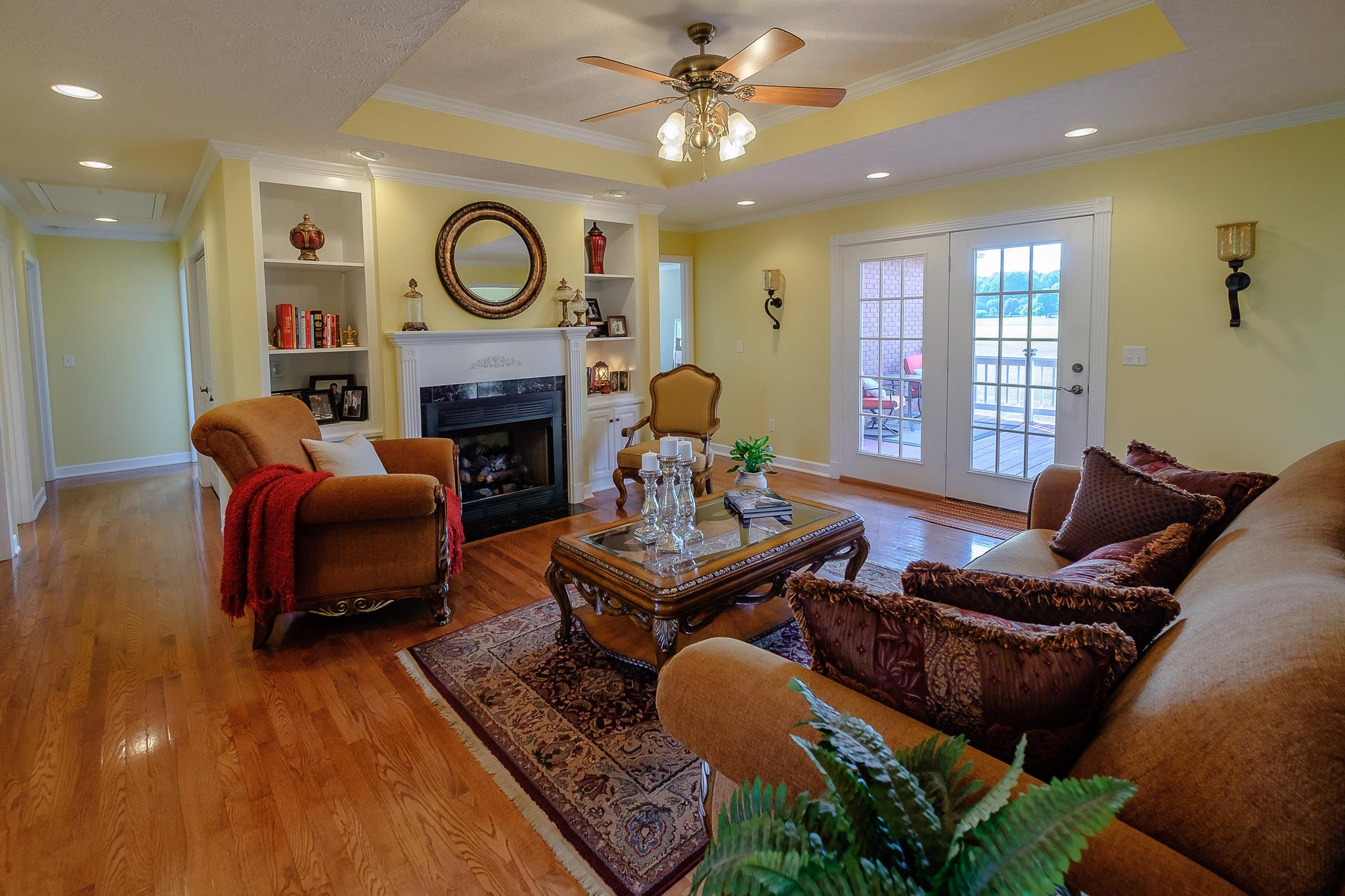 329 Urban Farms Road Manchester, TN 37355 - Photo 7 of 29 a living room with furniture a fireplace and a ceiling fan