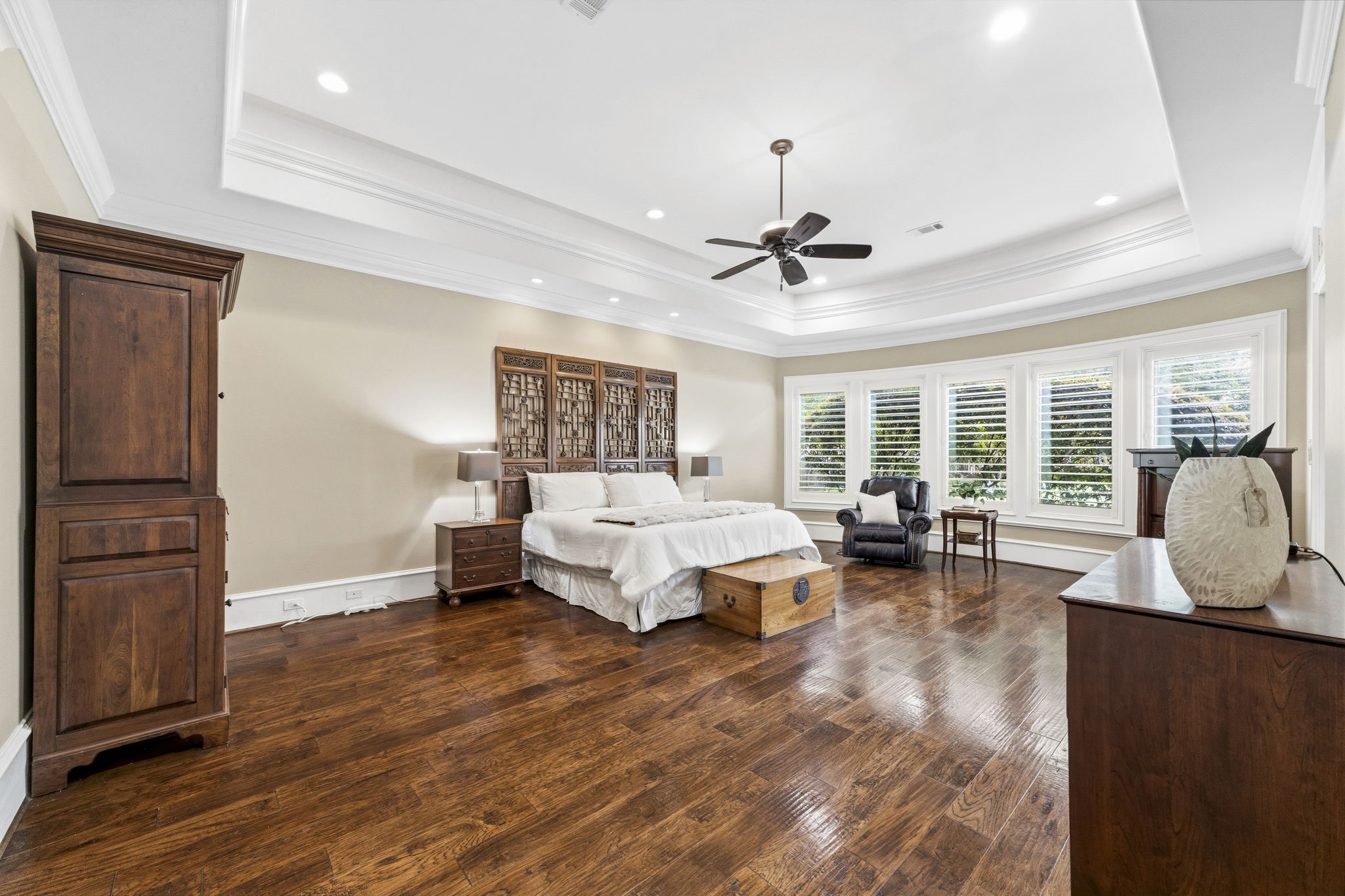 27402 Jacob's Path Lane Spring, TX 77386 - Photo 24 of 48 The spacious primary suite offers a peaceful retreat, featuring elegant tray ceilings and beautiful plantation shutters overlooking the backyard. The shutters provide both privacy and timeless style, a design feature thoughtfully incorporated throughout the home wherever privacy is desired. With generous proportions and serene views, this inviting suite is designed for comfort and relaxation.