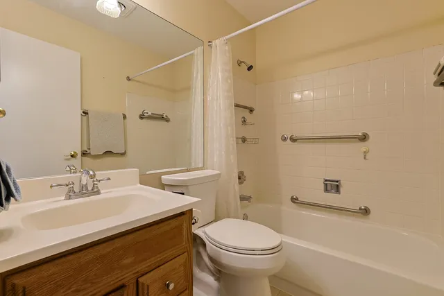 a bathroom with a sink mirror vanity and toilet