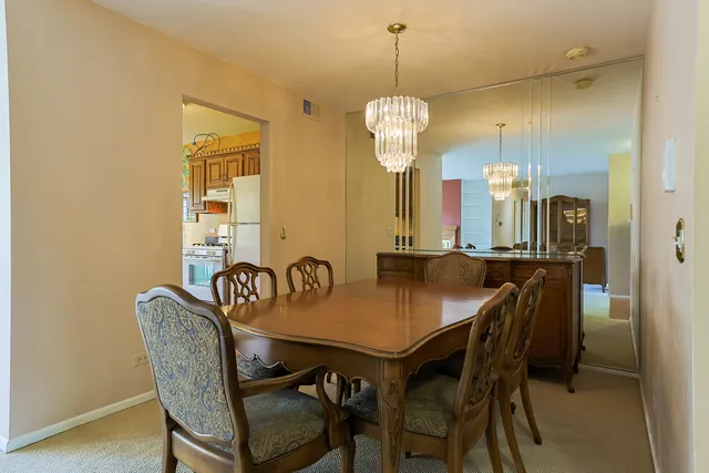 a view of a dining room a chandelier and wooden floor