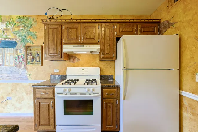 a kitchen with a stove and a refrigerator